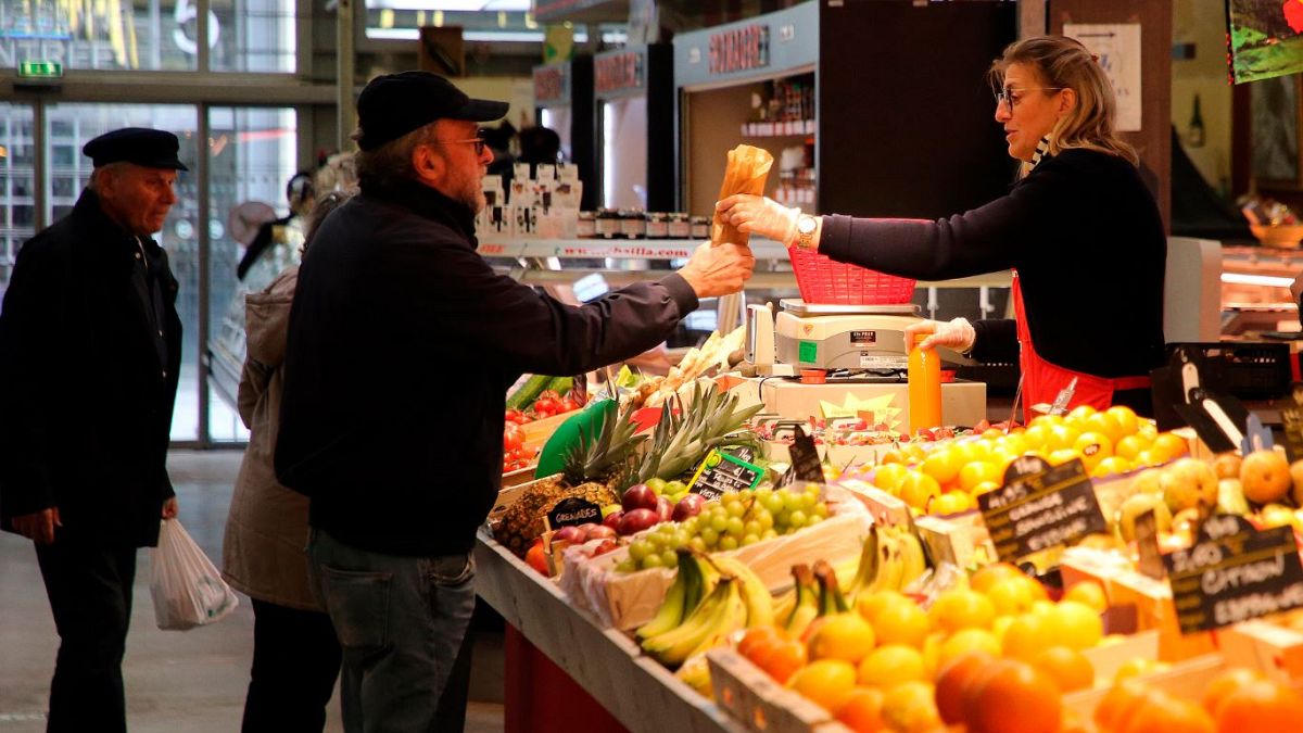 Customers no longer have to wear facemasks at a market in Biarritz, southwestern France.