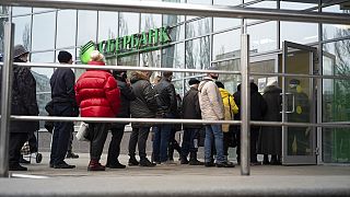 People stand in line to enter Sberbank in Moscow, Russia