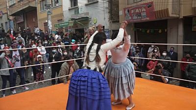 Young women dressed in billowing skirts and long braided hair take to the wrestling ring to fight anti-Indigenous racism in Bolivia.