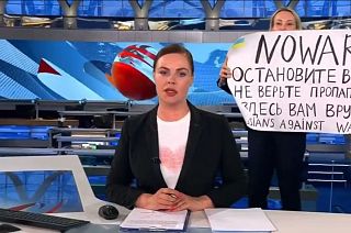 This photo reportedly shows an anti-war protester interrupting the Channel One broadcast.