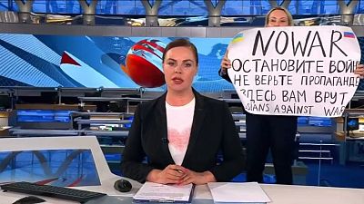 This photo reportedly shows an anti-war protester interrupting the Channel One broadcast. This photo reportedly shows an anti-war protester interrupting the Channel One broadcast.