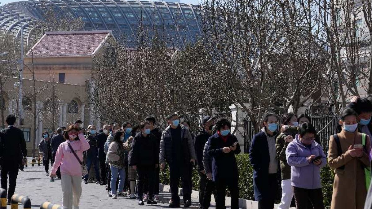 Koronavírustesztre várakozó emberek Pekingben 2022. március 14-én