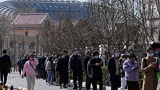 Koronavírustesztre várakozó emberek Pekingben 2022. március 14-én