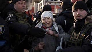 An elderly woman is helped by policemen after she was rescued by firefighters from inside her apartment after bombing in Kyiv, Ukraine, Tuesday, March 15, 2022. An elderly woman is helped by policemen after she was rescued by firefighters from inside her apartment after bombing in Kyiv, Ukraine, Tuesday, March 15, 2022.