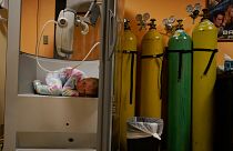 A 6-year-old girl curls up in the plethysmography chamber during a break in her pulmonary function test at Children's National Hospital, in Washington, Jan. 26, 2022.