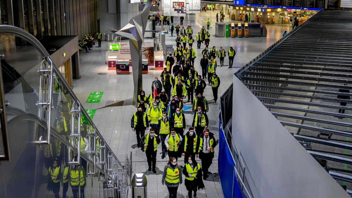 Security employees who control the flow of passengers and luggage walk through a terminal at the airport during a one day strike in Frankfurt, Germany.
