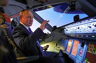 Russian President Vladimir Putin, who signed the new law, in the cockpit of an Aeroflot plane on 5 March.