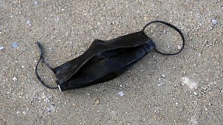 A dirty used protective face mask is abandoned on the ground in the Tuileries garden, in Paris, France, Monday, March 14, 2022.