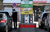 A driver fills his car tank in a petrol station in Marseille, southern France.