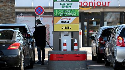 A driver fills his car tank in a petrol station in Marseille, southern France.