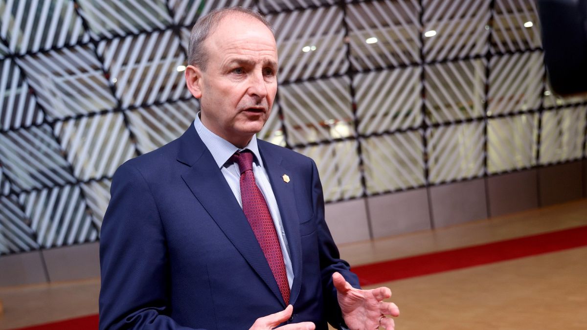 Ireland's Prime Minister Micheal Martin speaks with the media as he arrives for an EU Summit at the European Council building in Brussels, Thursday, Dec. 16, 2021.