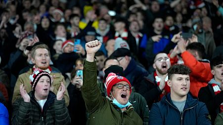 Sunderland fans cheer during the English League Cup quarterfinal match between Arsenal and Sunderland at Emirates stadium in London, Tuesday, Dec. 21, 2021