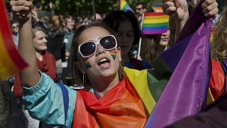 LGBT rights groups and supporters of the community hold banners during the country's first Gay Pride parade on Tuesday Oct. 10, 2017, in Kosovo's capital Pristina. 