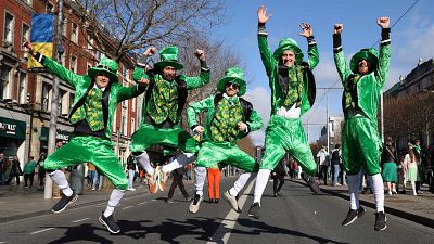 Revellers from Denmark dressed in green pose photo during the the annual St Patrick's Day parade in Dublin on March 17, 2022.