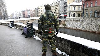 An Austrian NATO peacekeeping EUFOR soldier stops as during patrol in downtown Sarajevo, Bosnia, Monday, March 7, 2022. 
