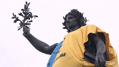 Statue of Marianne on the place de la Republique in Paris drapped in Ukrainian colours