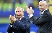 Vladimir Putin, left, applauds besides FIFA President Gianni Infantino