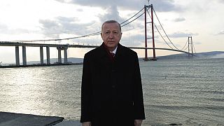 Turkey's President Recep Tayyip Erdogan poses for photos in front of the 1915 Canakkale Bridge, in Çanakkale,