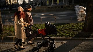 Casal passeia o filho de seis meses junto a uma barricada em Kiev