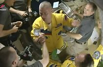 Newly-arrived to the ISS, Russian cosmonauts Denis Мatveev, centre, and Sergei Korsakov, right, bottom say hello to other participants of expedition.