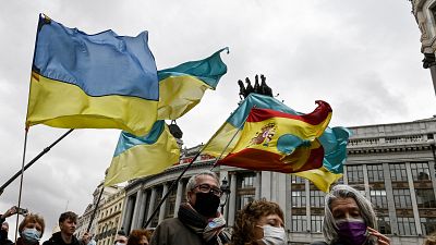 Demonstrators wave Ukrainian and Spanish flags during a protest against Russia's invasion of Ukraine, in Madrid.