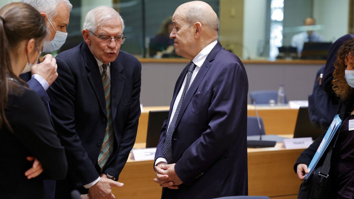 European foreign policy chief Josep Borrell, left, speaks with French Foreign Minister Jean-Yves Le Drian during a meeting of the EU foreign ministers
