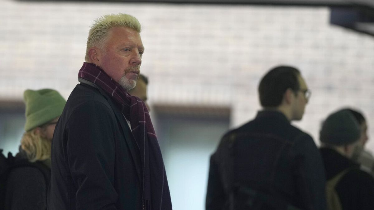 Former Wimbledon tennis champion Boris Becker, left, looks back as he waits in a queue to get into Southwark Crown Court in London