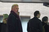 Former Wimbledon tennis champion Boris Becker, left, looks back as he waits in a queue to get into Southwark Crown Court in London