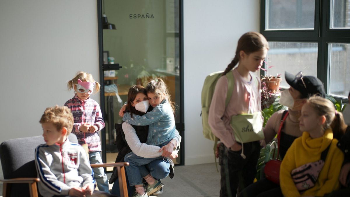 Refugee children from Ukraine wait with their mothers for the start of their classes in Berlin, Germany, March 21, 2022. 