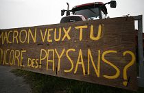 A tractor, with a placard reading "Macron, do you still want to have farmers?" in Lespinasse, near Toulouse.