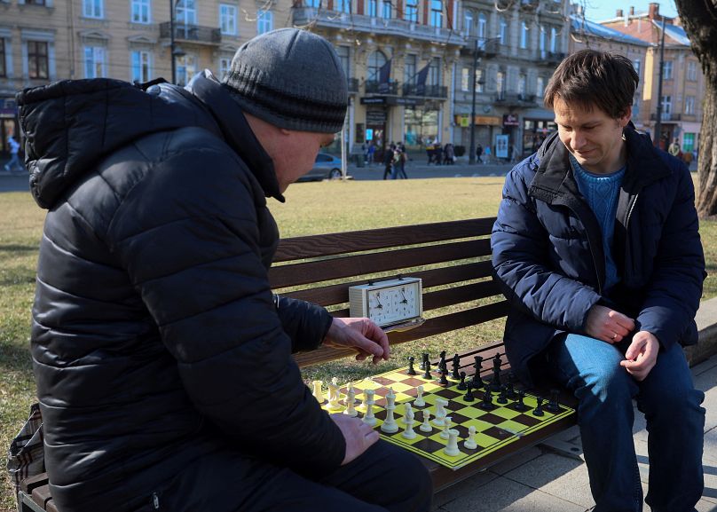 Two zoomers play the old game of chess 