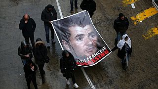 Protesters hold a portrait of Yvan Colonna during a rally in Bastia on the island of Corsica.
