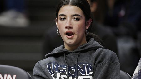 TikTok star Charli D'Amelio yawns during an NCAA college basketball game between Connecticut and Seton Hall, Wednesday, Feb. 16, 2022.