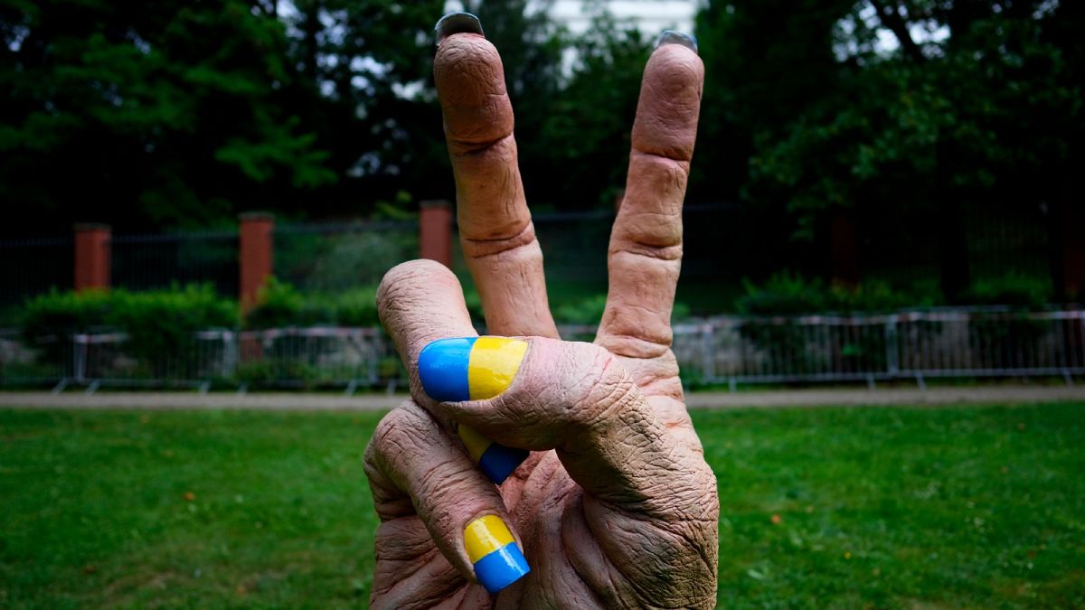 A statue of a hand with finger nails painted in Ukraine's national colors was placed in front of the Russian embassy in Prague, Czech Republic, Wednesday, Aug. 24, 2022