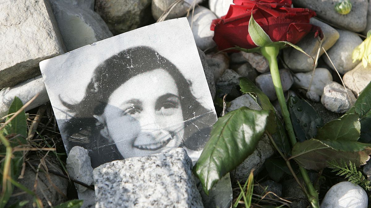 A red rose and a photo of Anne Frank lay at a memorial stone of Jewish sisters Margot and Anne Frank at the Bergen-Belsen Memorial, northern Germany, Sunday, Oct. 28, 2007