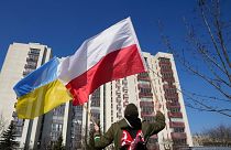 یک فرد در مقابل سفارت روسیه در لهستان پرچم‌های لهستان و اوکراین را به اهتزاز درآورد