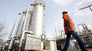 An employee of energy company EonHanse walks across the premises of the natural gas storage facility in Hamburg-Reitbrook, Germany