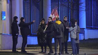 A group of people gather for a protest to show solidarity with the country during the tensions with Russia, outside the Russian Embassy in Warsaw, Poland, on Feb. 23, 2022.