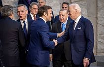 U.S. President Joe Biden and French President Emmanuel Macron talk during an extraordinary NATO summit in Brussels
