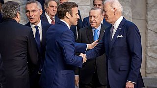 U.S. President Joe Biden and French President Emmanuel Macron talk during an extraordinary NATO summit in Brussels