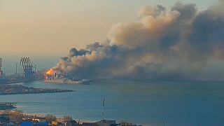 Russian ship gutted by flames and explosions in the Ukrainian port of Berdyansk as a fire also burns on one of two naval ships leaving the area.