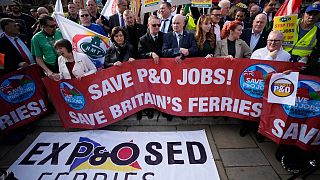 People take part in a union protest in solidarity with 800 P&O Ferries workers fired last week, opposite the Houses of Parliament, in London, Monday, March 21, 2022. 