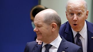 U.S. President Joe Biden, right, puts his hand on the shoulder of German Chancellor Olaf Scholz as he arrives for a round table meeting at an EU summit in Brussels
