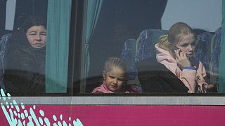 Refugees look out from a bus after fleeing the war from neighbouring Ukraine, at the border crossing in Palanca, Moldova