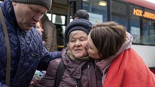 An elderly Ukrainian woman is welcomed in Korczowa on the Polish-Ukrainian border