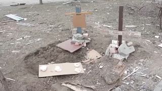 Makeshift graves of people killed during shelling in Mariupol - 26th March 2022