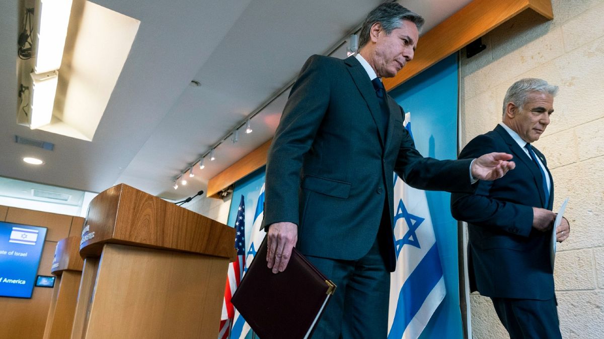 US Secretary of State Antony Blinken, left, and Israel's Foreign Minister Yair Lapid walk together after a news conference