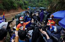 A rescue team member briefs media near the China Eastern crash site Thursday, March 24, 2022, in Molang village, in southwestern China's Guangxi province. 