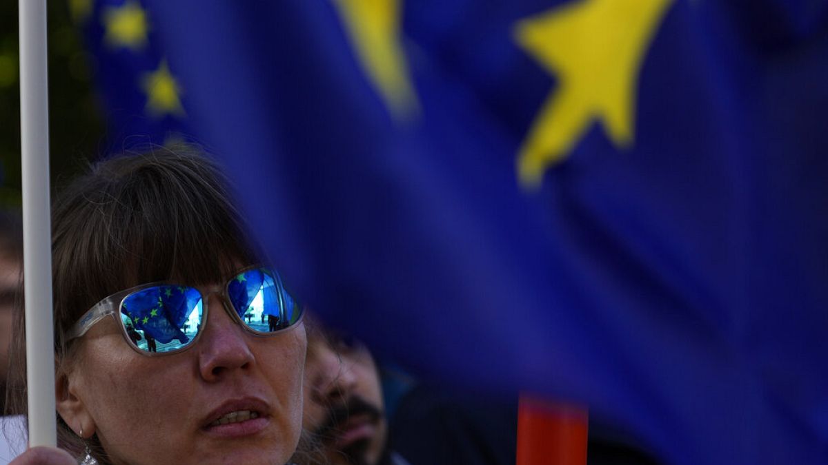 A protester waves a European Union flag during a protest against Russia's invasion of Ukraine