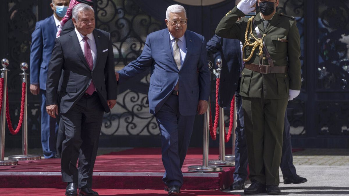 Palestinian President Mahmoud Abbas, right receives Jordan's King Abdullah II,
